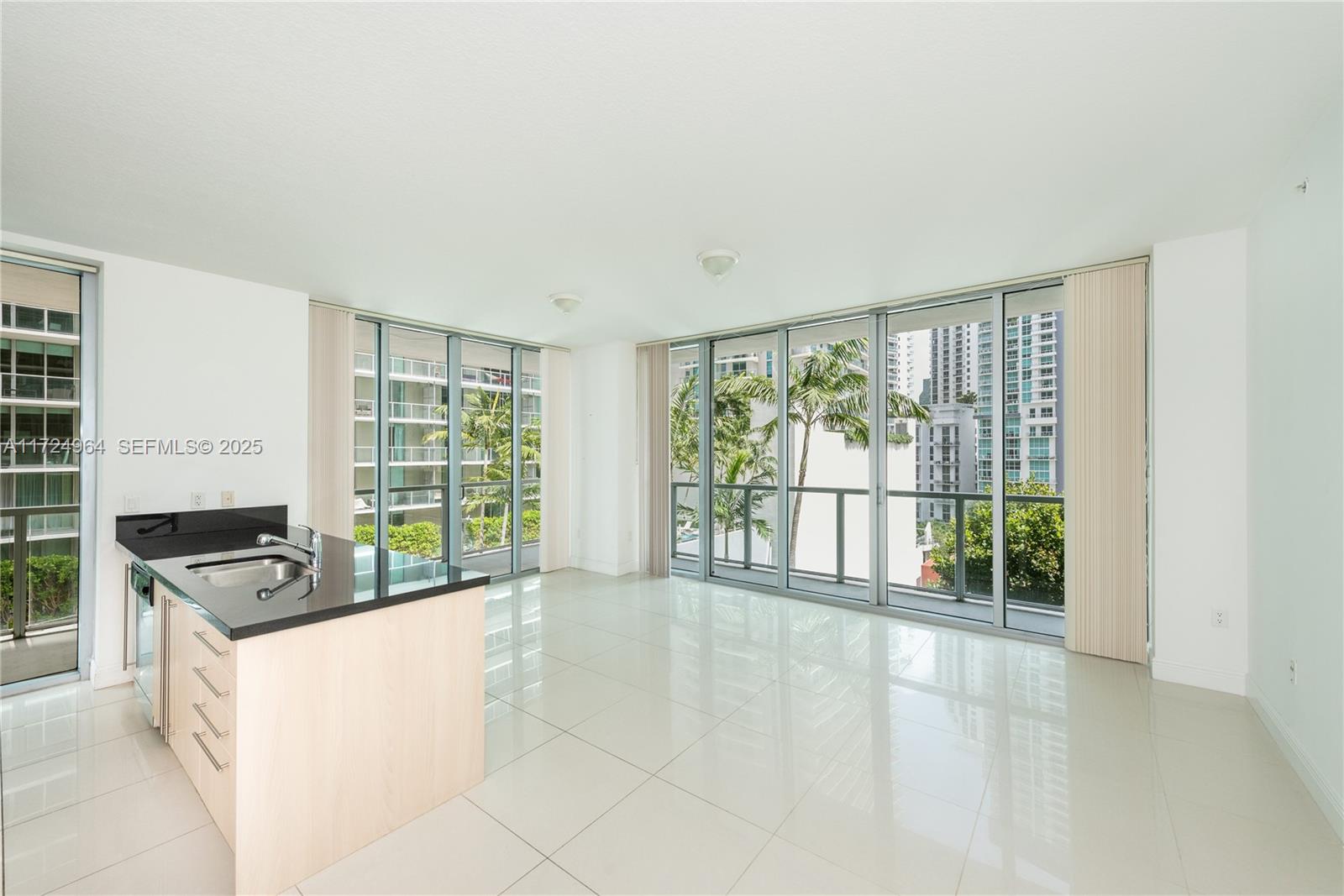 79 Southwest 12th Street, Unit 1107S Miami, FL 33130 - Photo 1 of 26 a large white kitchen with a large window