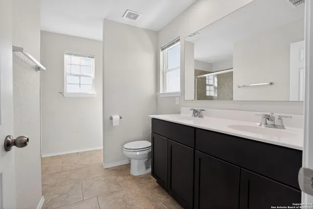 a bathroom with a sink toilet a mirror and vanity