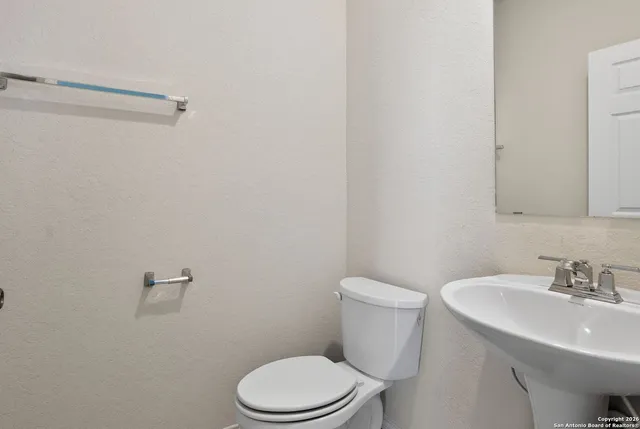 a white toilet sitting next to a bathroom sink