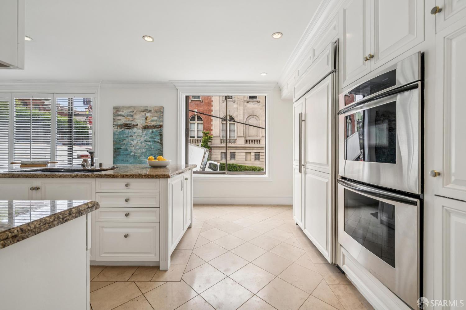 2190 Broadway, Unit 1W San Francisco, CA 94115 - Photo 21 of 66 a kitchen with stainless steel appliances a large window and a refrigerator