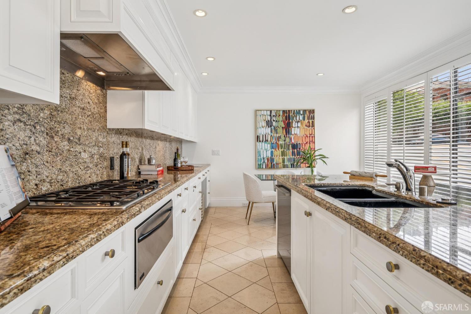 2190 Broadway, Unit 1W San Francisco, CA 94115 - Photo 22 of 66 a kitchen with stainless steel appliances granite countertop a sink stove and cabinets