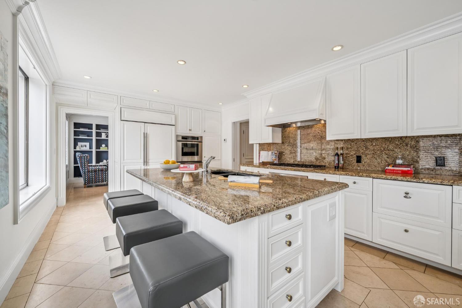 2190 Broadway, Unit 1W San Francisco, CA 94115 - Photo 23 of 66 a kitchen with granite countertop a sink and white cabinets