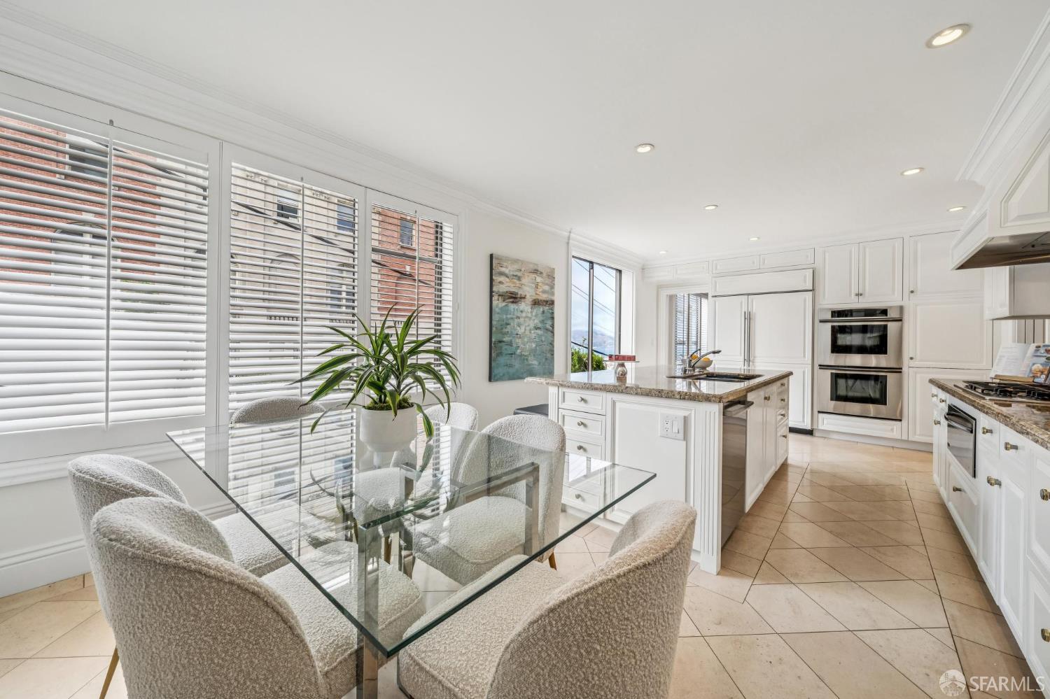 2190 Broadway, Unit 1W San Francisco, CA 94115 - Photo 28 of 66 a white kitchen with cabinets and stainless steel appliances