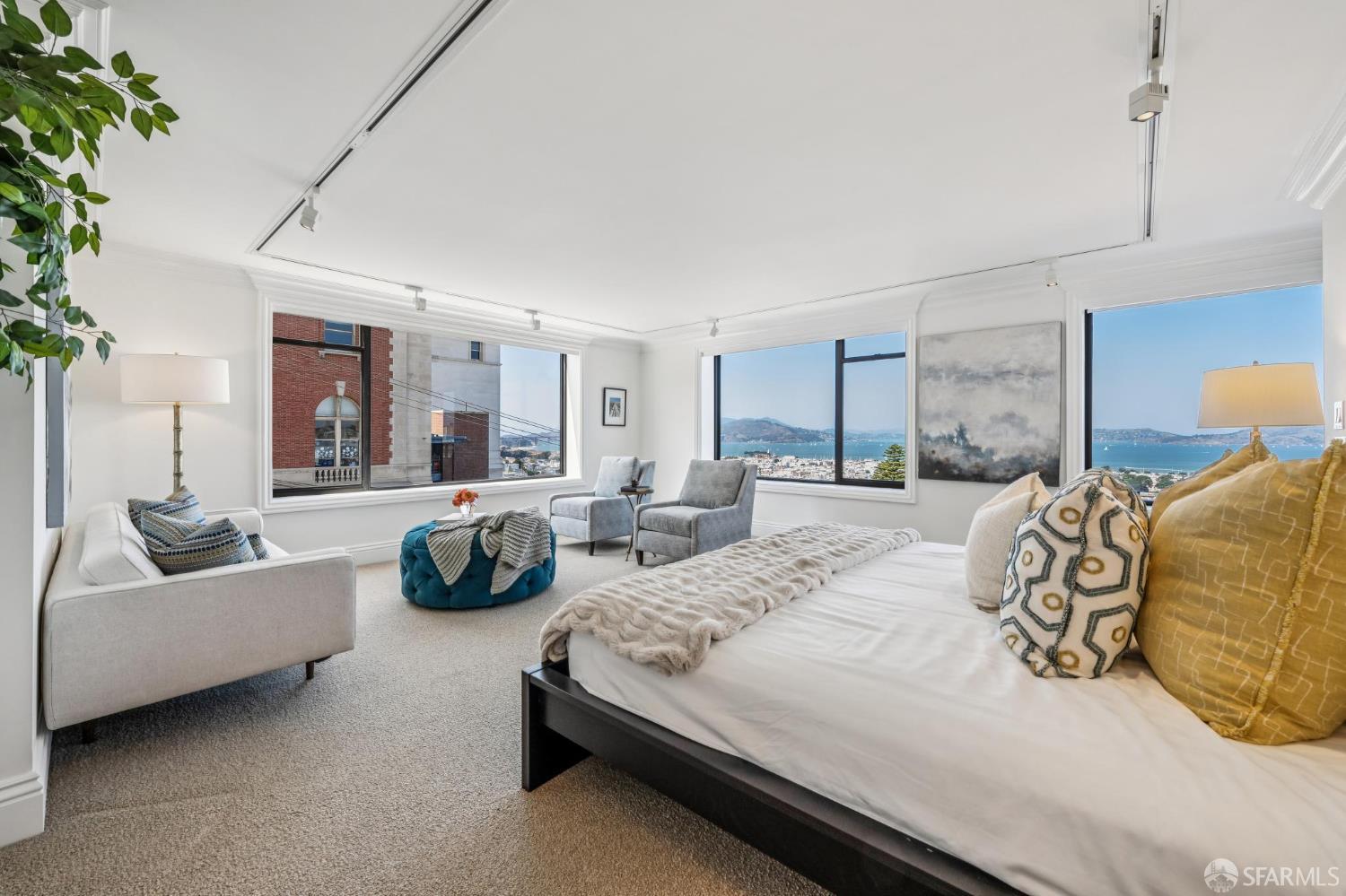 2190 Broadway, Unit 1W San Francisco, CA 94115 - Photo 35 of 66 a spacious bedroom with a bed a couch and a potted plant