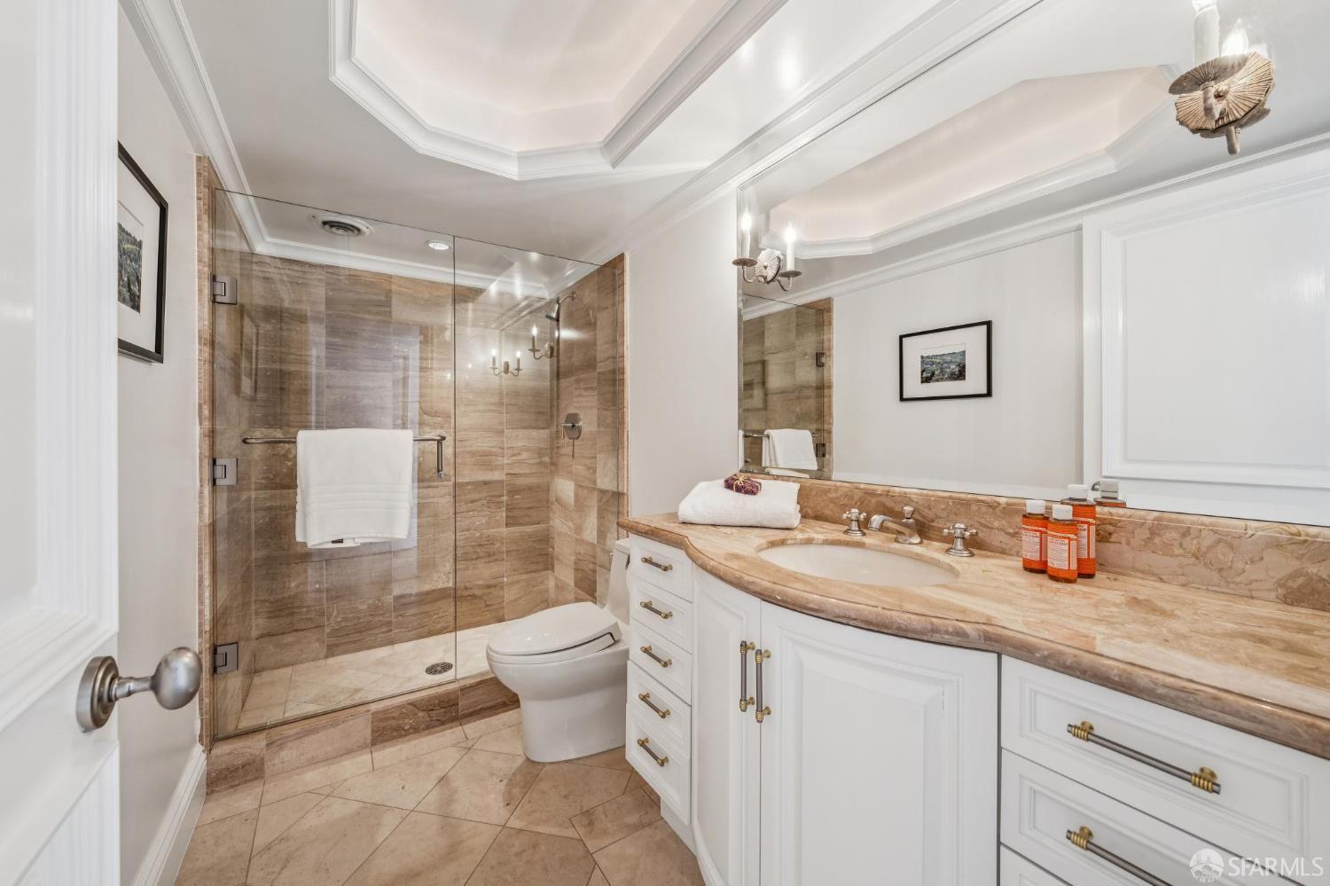 2190 Broadway, Unit 1W San Francisco, CA 94115 - Photo 58 of 66 a bathroom with a granite countertop sink toilet mirror and shower