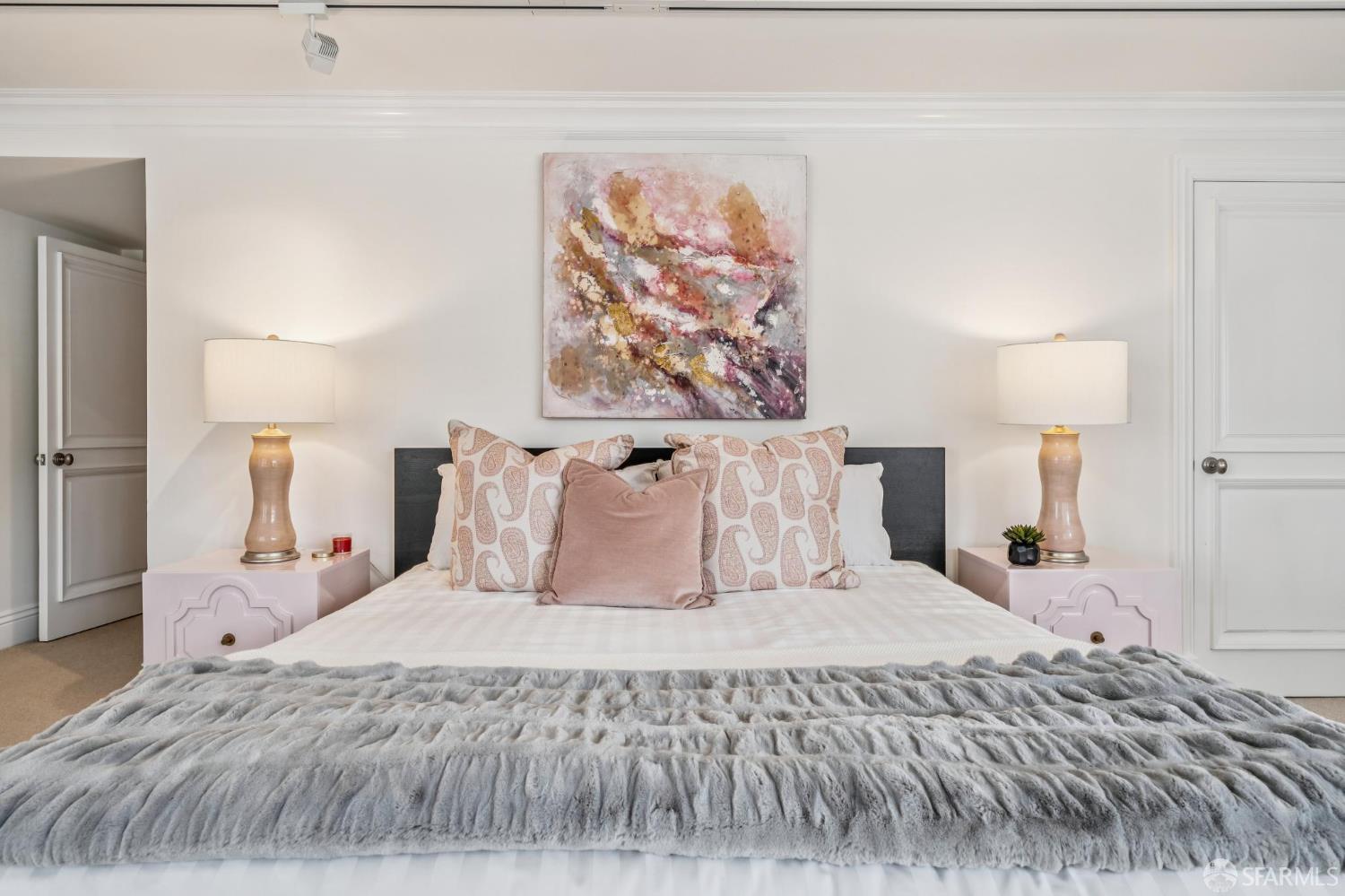 2190 Broadway, Unit 1W San Francisco, CA 94115 - Photo 59 of 66 a bedroom with a large bed and a painting on the wall