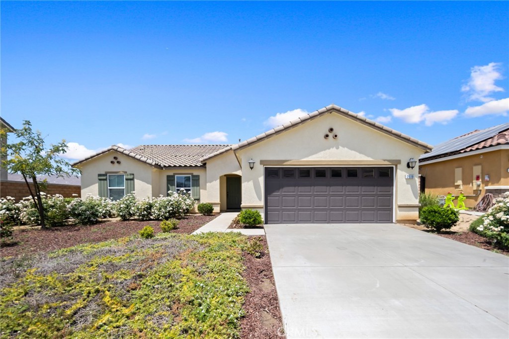 7519 Silverspot Road Riverside, CA 92507 - Photo 1 of 1 a front view of a house with a yard and garage