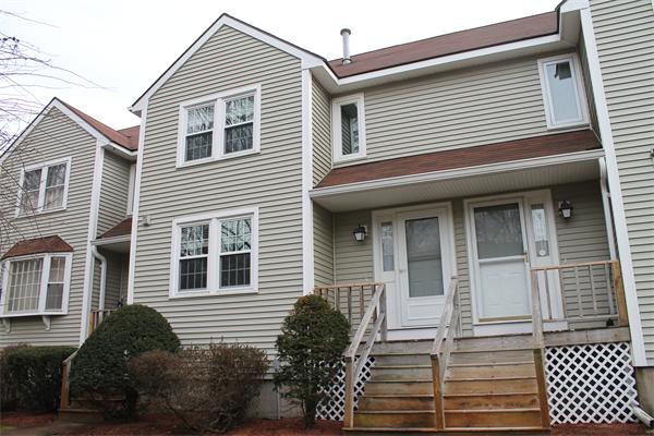 133 Patrick Road, Unit 133 Tewksbury, MA 01876 - Photo 1 of 30 a front view of a house