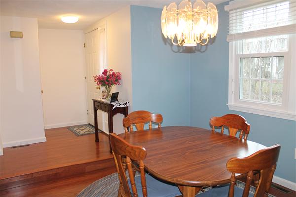 133 Patrick Road, Unit 133 Tewksbury, MA 01876 - Photo 11 of 30 a view of a dining room with furniture and chandelier