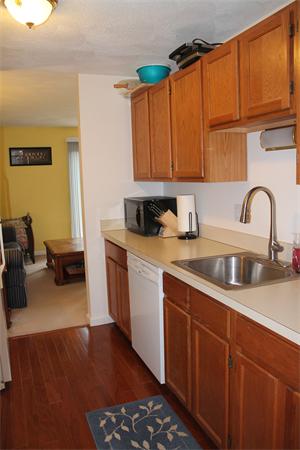 133 Patrick Road, Unit 133 Tewksbury, MA 01876 - Photo 12 of 30 a kitchen with stainless steel appliances granite countertop a sink dishwasher stove and cabinets with wooden floor
