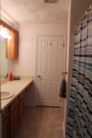 133 Patrick Road, Unit 133 Tewksbury, MA 01876 - Photo 18 of 30 a bathroom with a sink and a mirror