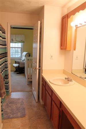133 Patrick Road, Unit 133 Tewksbury, MA 01876 - Photo 19 of 30 a en suite bathroom with a sink a mirror and a shower