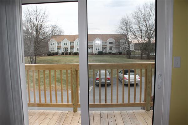 133 Patrick Road, Unit 133 Tewksbury, MA 01876 - Photo 5 of 30 a view of house with outdoor seating