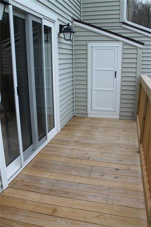 133 Patrick Road, Unit 133 Tewksbury, MA 01876 - Photo 6 of 30 a view of a backyard of the house