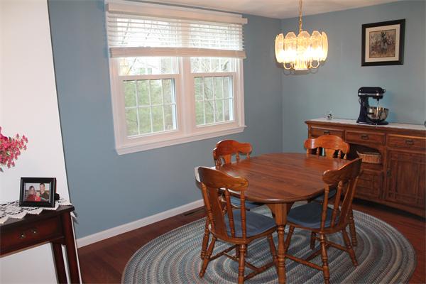 133 Patrick Road, Unit 133 Tewksbury, MA 01876 - Photo 10 of 30 a dining room with furniture and chandelier
