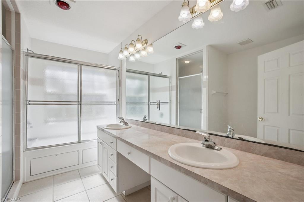 5348 Cypress Lane Naples, FL 34113 - Photo 15 of 28 a bathroom with a sink double vanity and a mirror