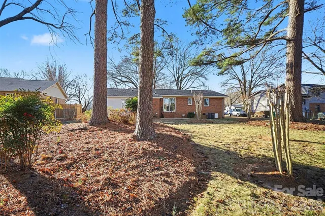 a view of a house with a yard covered in snow