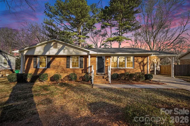 a front view of a house with large windows