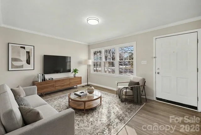 a living room with furniture and a flat screen tv