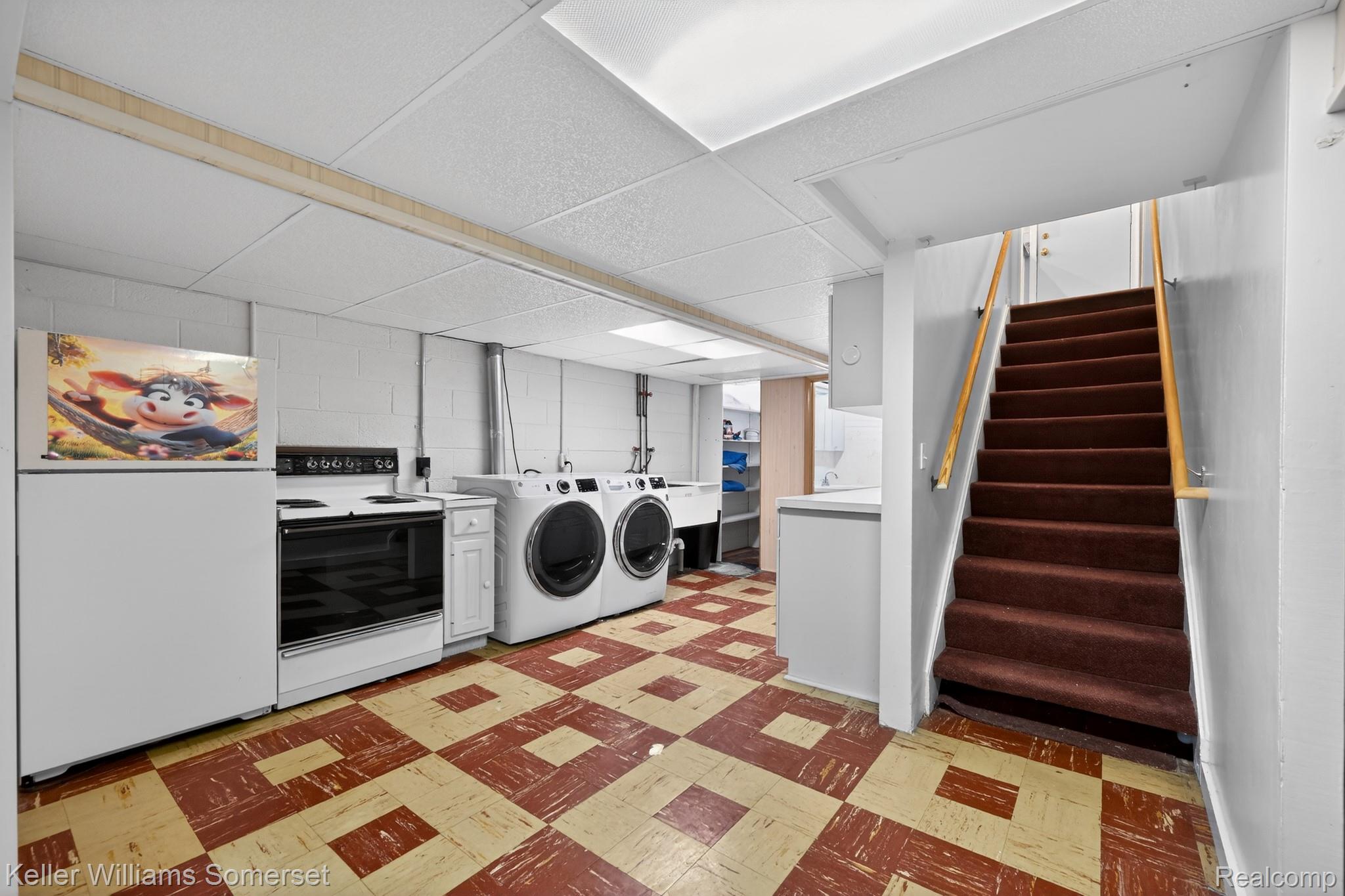 1681 Oxford Road Grosse Pointe, MI 48236 - Photo 19 of 25 Laundry area featuring light flooring, separate washer and dryer, and a drop ceiling