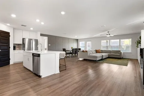 a living room with furniture and kitchen view