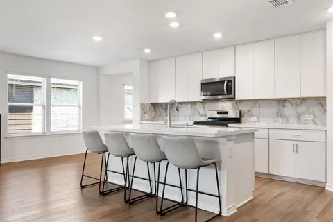 a kitchen with a sink cabinets and window