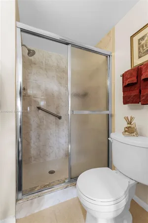 a bathroom with a shower a toilet and a sink