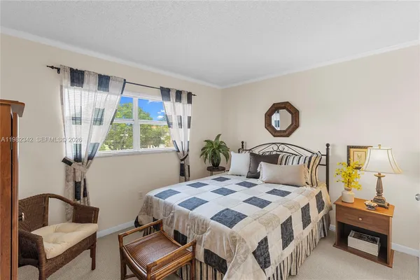 a bedroom with a bed and a chair