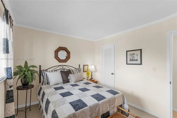 a bedroom with a bed and a potted plant