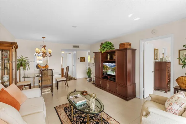 a living room with furniture a rug and a chandelier