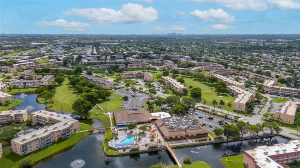 an aerial view of a houses with a swimming pool