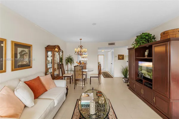 a living room with furniture wooden floor and a flat screen tv