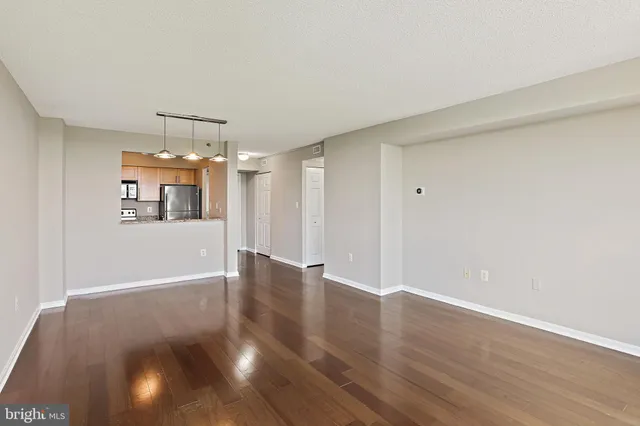 a view of a room with wooden floor