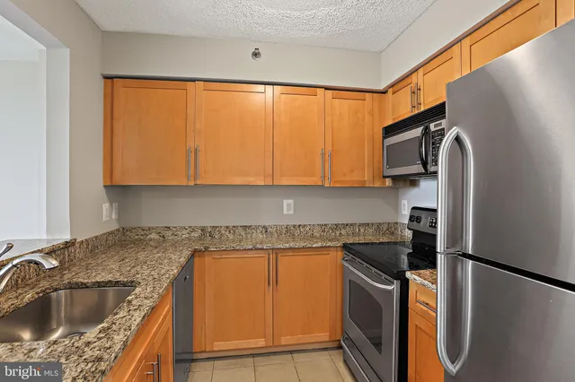 a kitchen with a refrigerator sink and stove