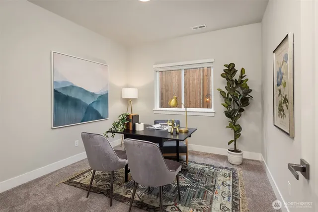 a view of a dining room with furniture and window