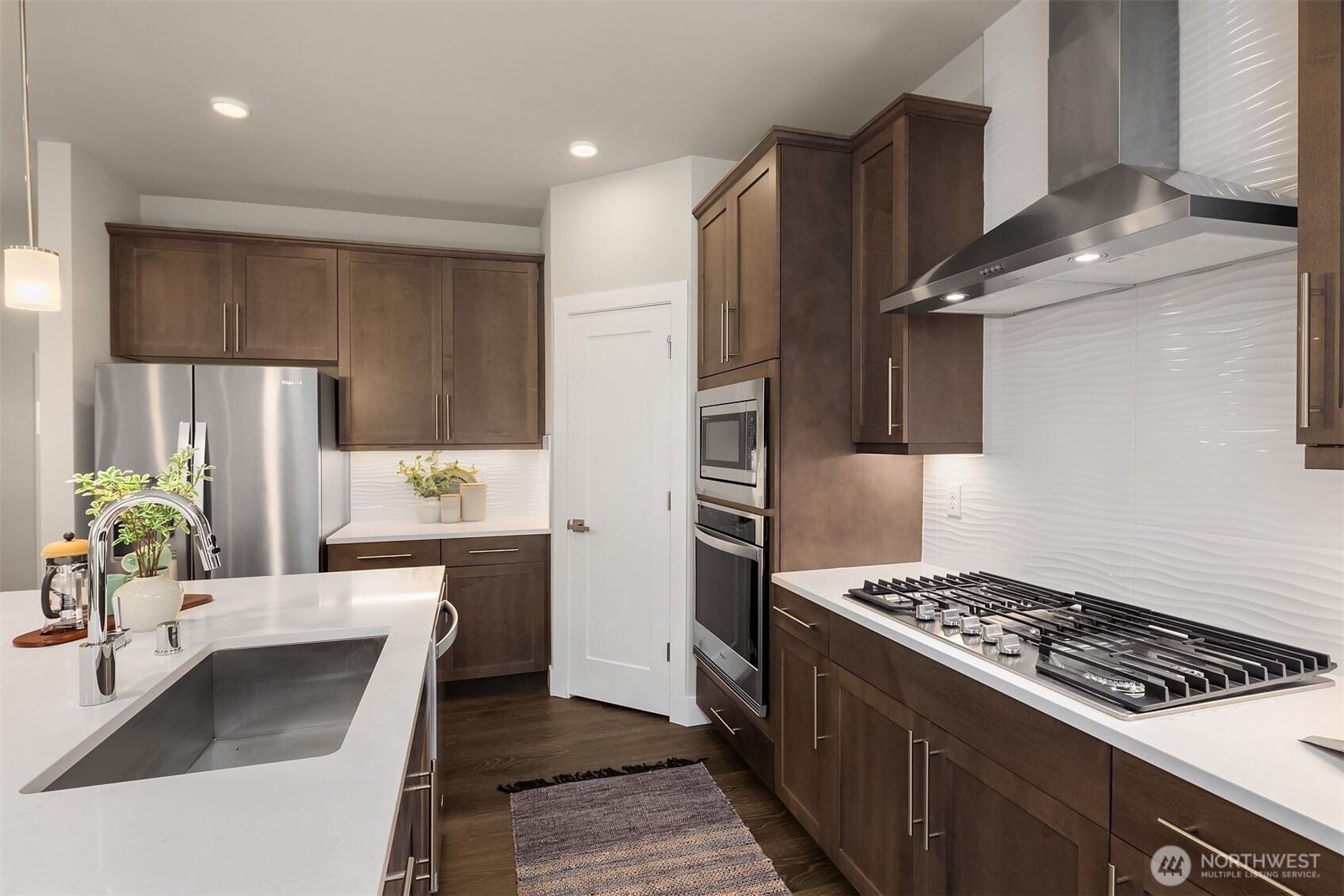2015 228th Place Southwest Bothell, WA 98021 - Photo 15 of 40 a kitchen with kitchen island stainless steel appliances a sink stove and refrigerator