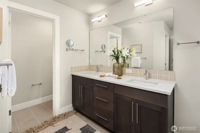 a bathroom with a double vanity sink and mirror