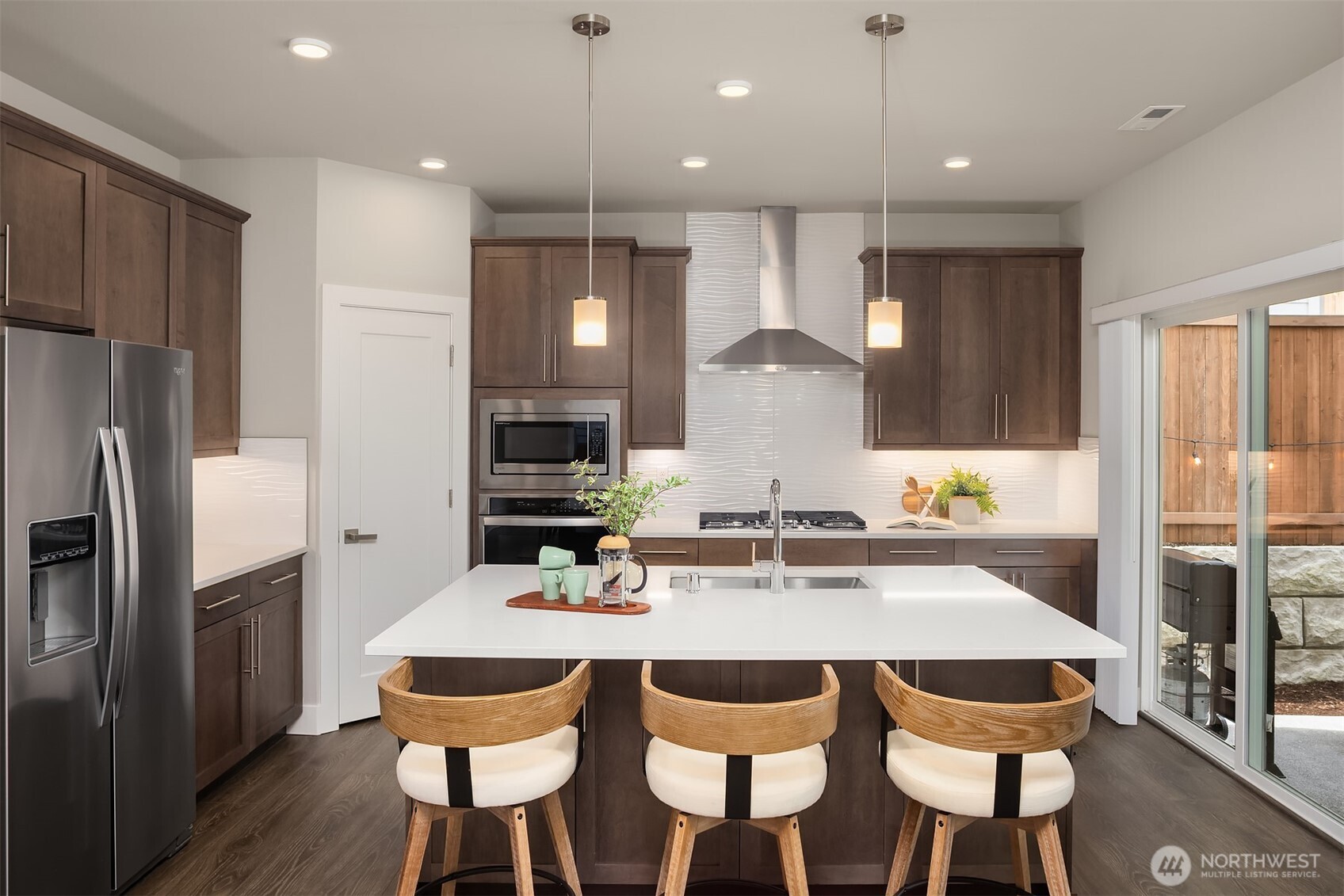 2015 228th Place Southwest Bothell, WA 98021 - Photo 5 of 40 a kitchen with a dining table chairs stainless steel appliances and cabinets