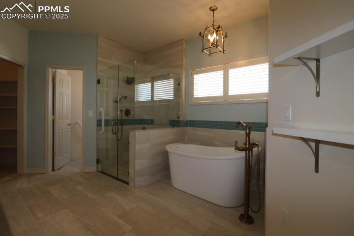 4015 Ramshorn Point Colorado Springs, CO 80904 - Photo 20 of 44 a spacious bathroom with a bathtub sink and mirror