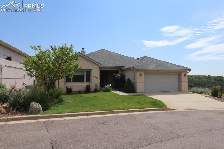 4015 Ramshorn Point Colorado Springs, CO 80904 - Photo 2 of 44 a view of a house with a yard and large tree