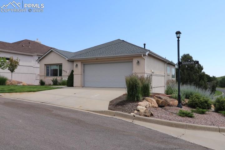 4015 Ramshorn Point Colorado Springs, CO 80904 - Photo 3 of 44 a front view of a house with a yard and garage