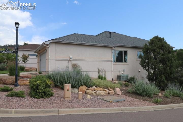 4015 Ramshorn Point Colorado Springs, CO 80904 - Photo 4 of 44 a backyard of a house with a bench and plants