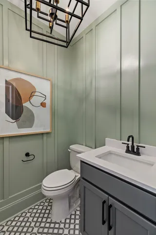 a bathroom with a sink a toilet a mirror and shower