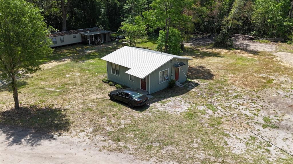 12100 Northwest US Highway 441 Alachua, FL 32615 - Photo 13 of 34 a view of a backyard with a small cabin