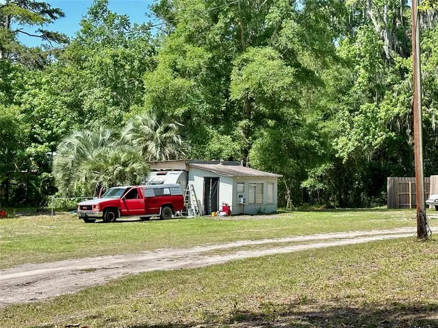 a view of a house with yard and sitting area