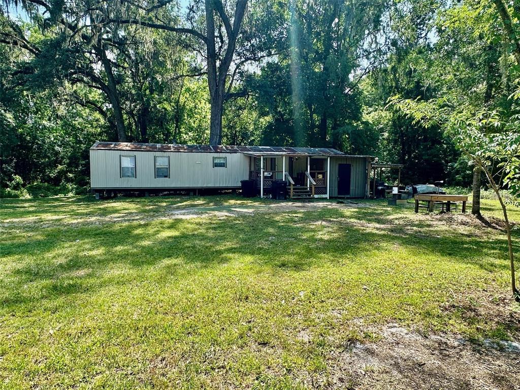 12100 Northwest US Highway 441 Alachua, FL 32615 - Photo 16 of 34 a view of a house with yard and sitting area