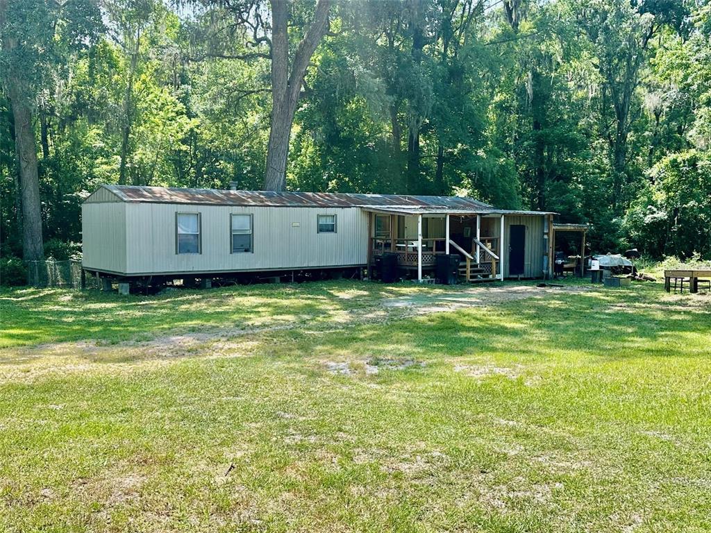 12100 Northwest US Highway 441 Alachua, FL 32615 - Photo 17 of 34 a view of a house with yard and trees