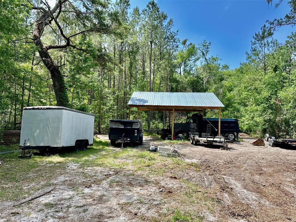 12100 Northwest US Highway 441 Alachua, FL 32615 - Photo 18 of 34 a backyard of a house with barbeque oven and outdoor seating