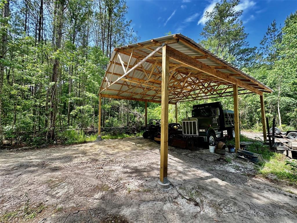 12100 Northwest US Highway 441 Alachua, FL 32615 - Photo 19 of 34 a view of a wooden house with a yard
