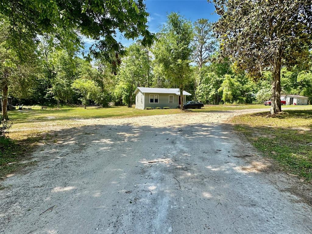 12100 Northwest US Highway 441 Alachua, FL 32615 - Photo 7 of 34 a house with trees in front of it